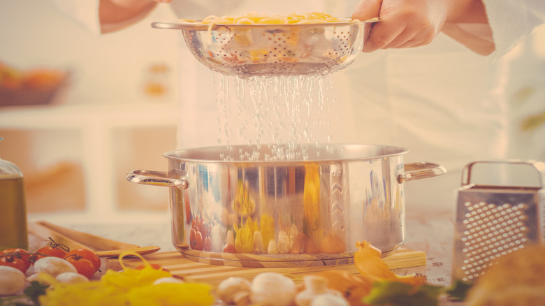 Close up of chef cooking spaghetti pasta.