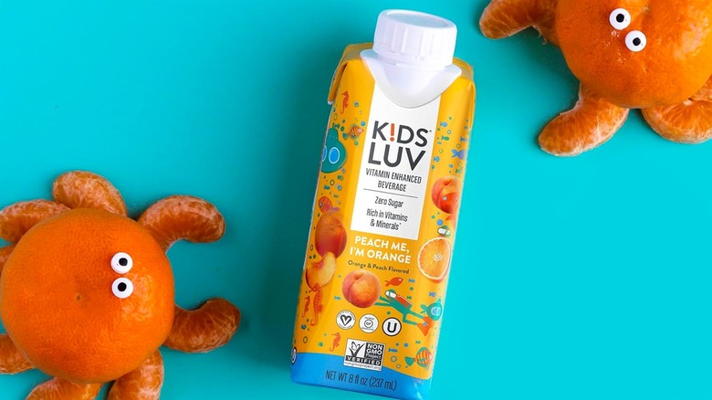 KidsLuv beverage next to oranges mimicking octopi