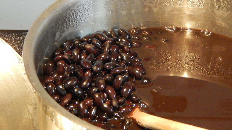 Black beans cooking in stainless steel pot