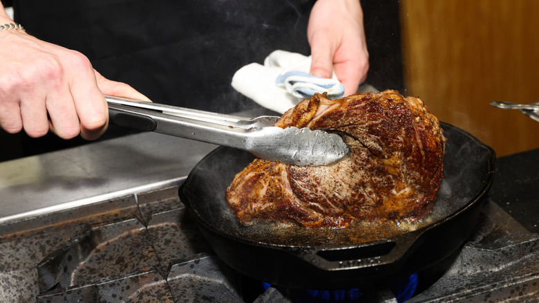 Steak is cooked in a cast iron skillet