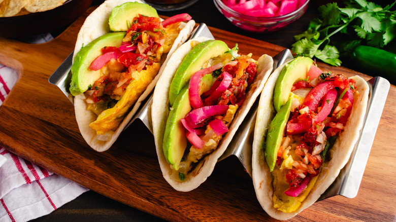 Breakfast tacos with eggs, guacamole and other toppings