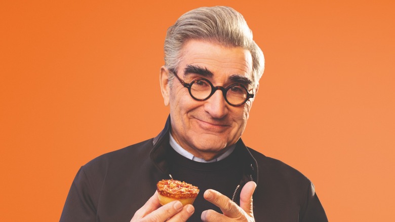 Eugene Levy holding Little Caesars' Crazy Bite