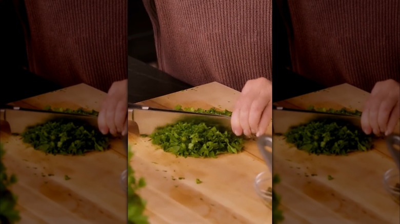 martha stewart cutting herbs with two knives