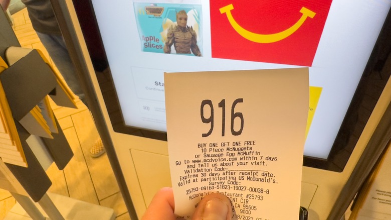 hand holding a McDonald's receipt