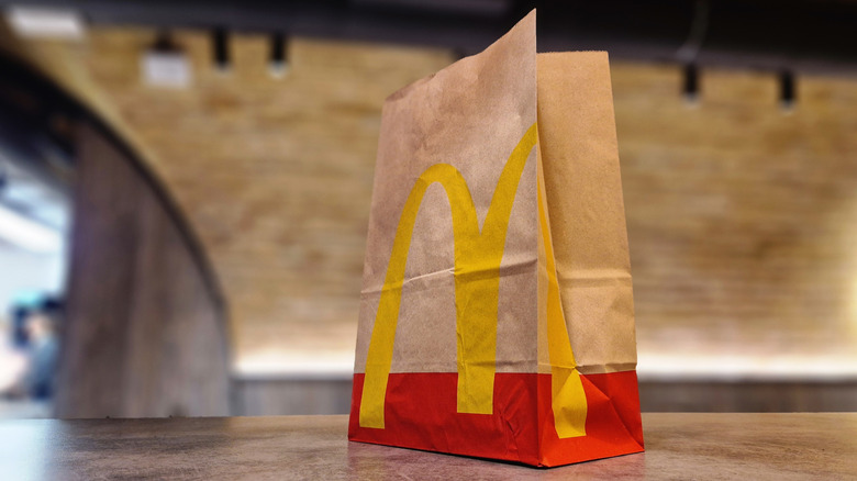 McDonald's bag on table from low angle.