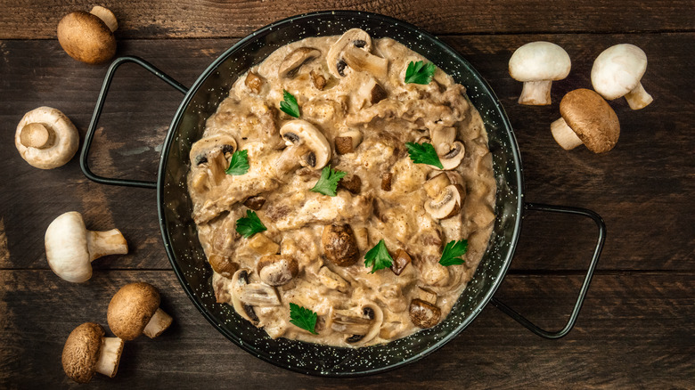 Beef stroganoff with mushrooms on wooden table