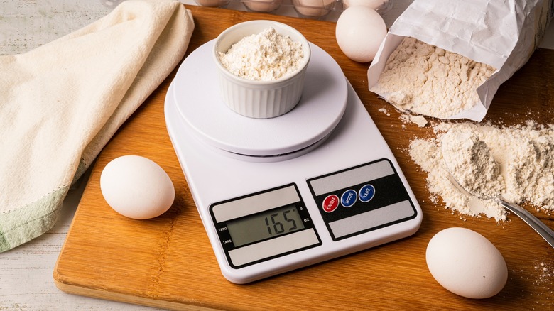 weighing flour on kitchen scale