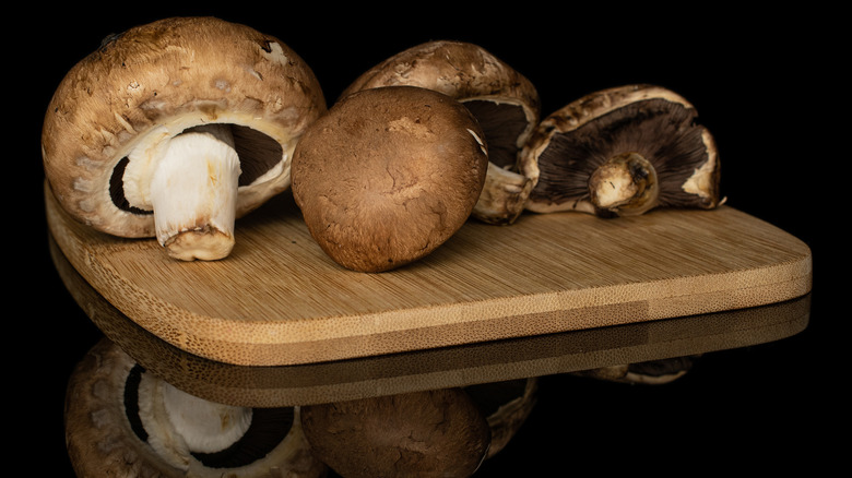 Portobella mushrooms on cutting board