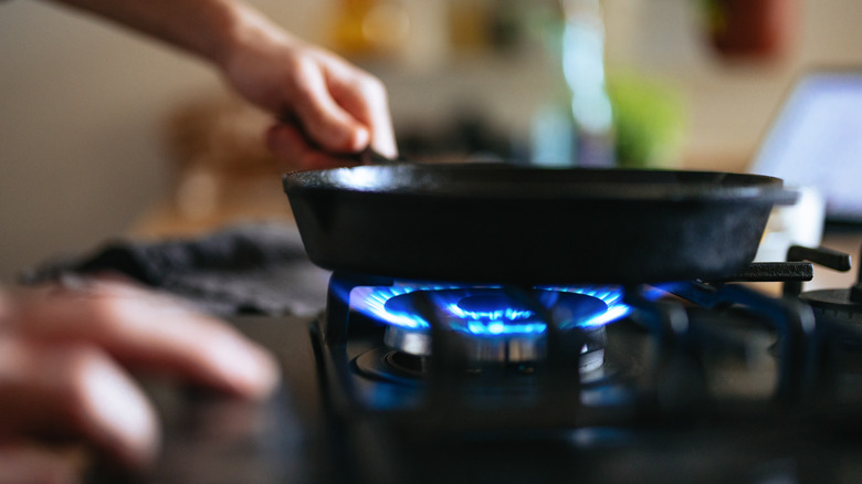 A pan heating over a stovetop