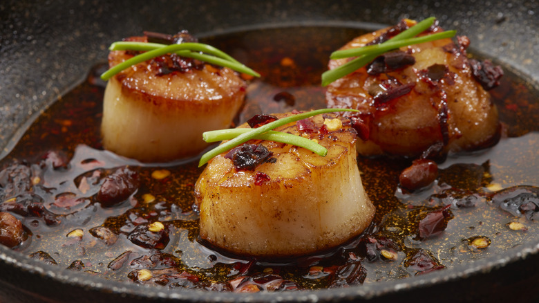 Scallops cooking in chili oil