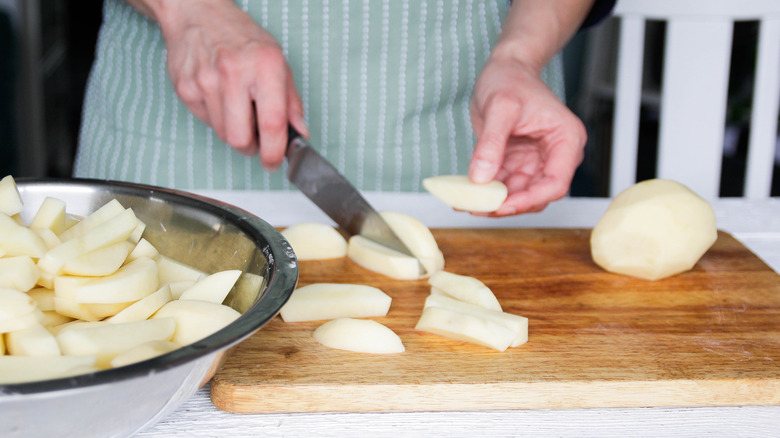 cutting potatoes with knife