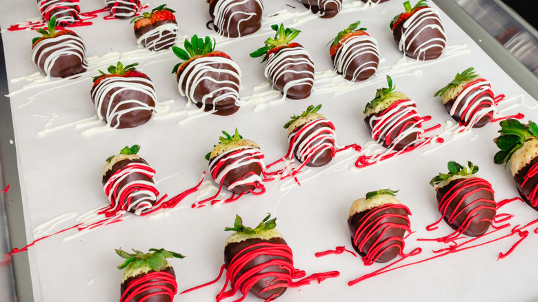 Chocolate-covered strawberries on parchment paper