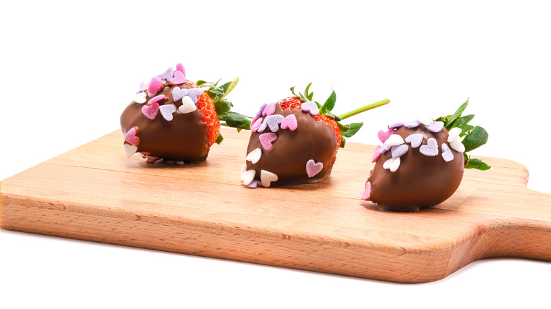 Chocolate-covered strawberries with heart-shaped sprinkles