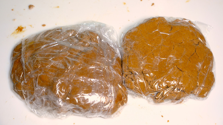 Plastic-wrapped gingerbread dough ready to chill