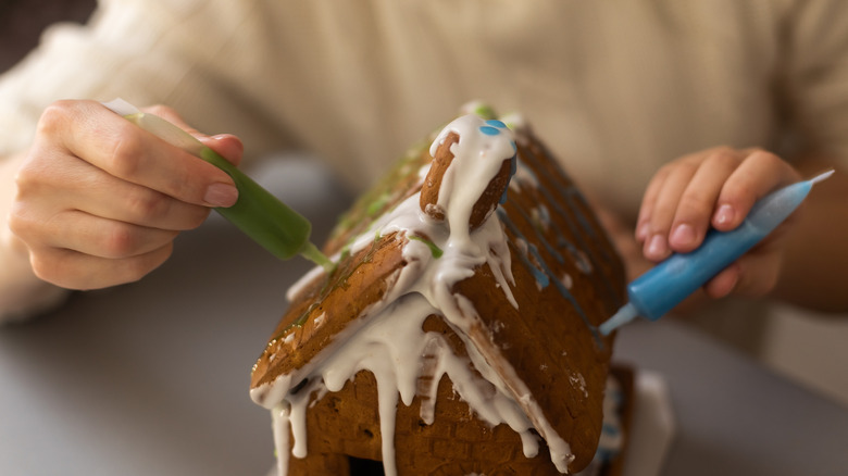 Icing running down the side of a gingerbread house