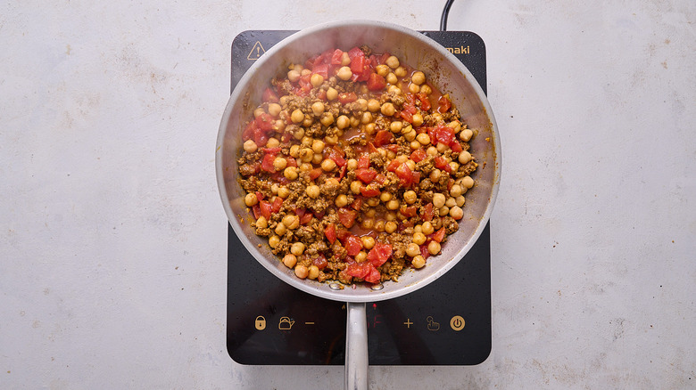 Chickpeas and tomatoes in skillet