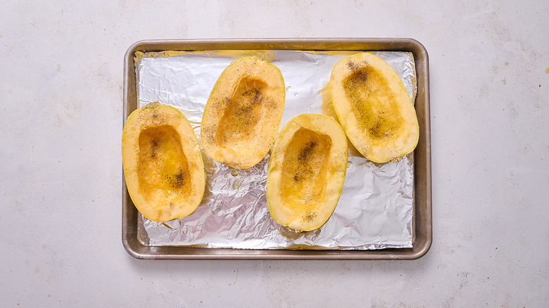 seasoned spaghetti squash on sheet tray