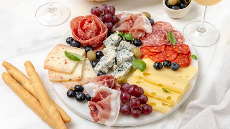 A charcuterie board with 3 cheese options