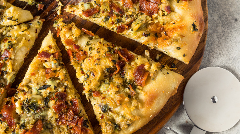 Sliced New Haven clam white pizza with oregano and bacon