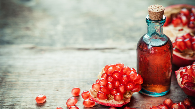 small bottle of pomegranate syrup with seeds