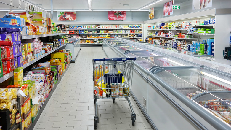 Interior of Aldi store with cold cases and shopping cart