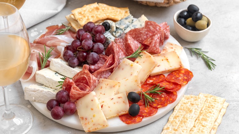 Charcuterie board with cheese, meat, crackers