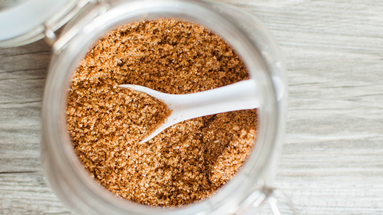 High angle view of brown sugar in a glass jar.