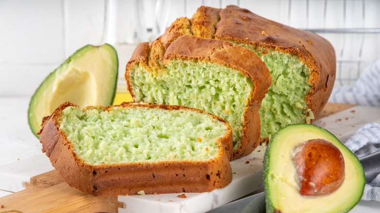 Avocado bread on board with halved avocados