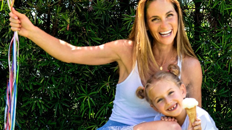 Peekaboo Ice Cream founder Jessica Levison with a child holding ice cream