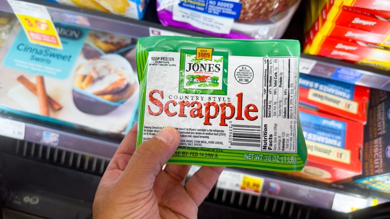 A person holding a pack of scrapple