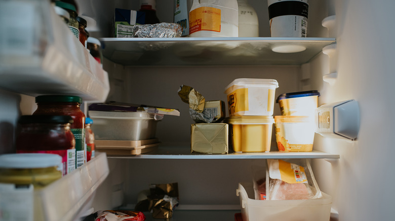 A fridge containing tubs of food