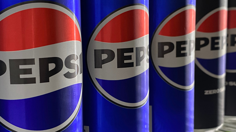 Pepsi cans lined up on store shelf