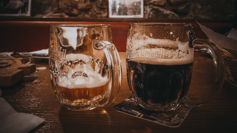 Two beer mugs on wooden table