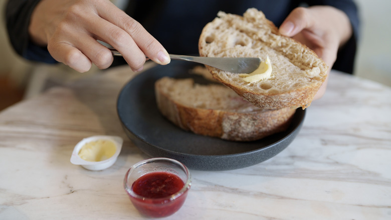 Refreshed sourdough bread slices with butter and jam