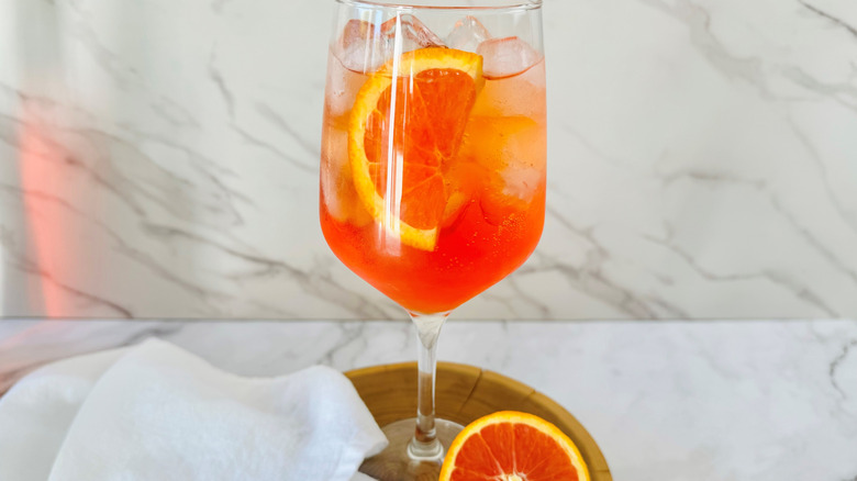 orange cocktail in wine glass