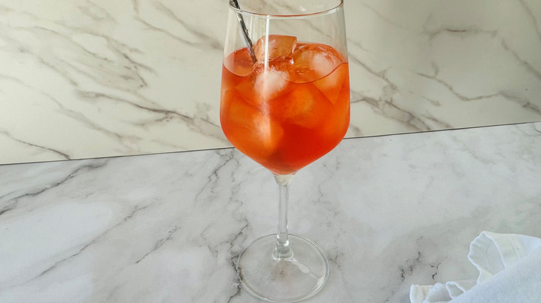 orange cocktail in wine glass