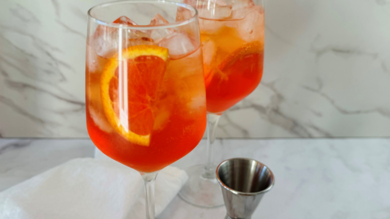 orange cocktails in wine glasses