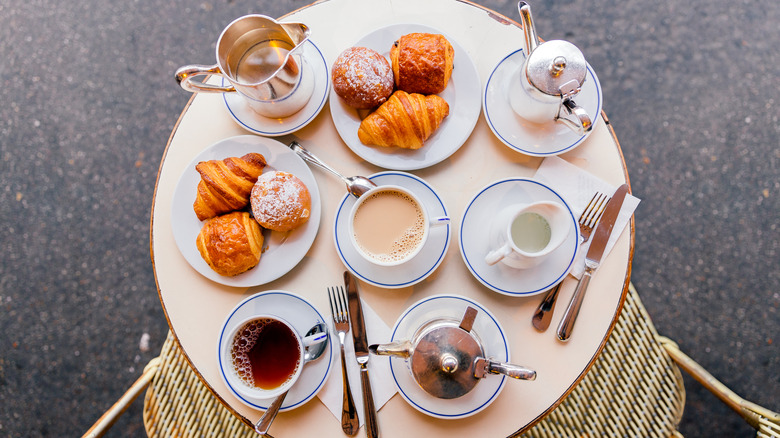 Table filled with coffee and French pastries