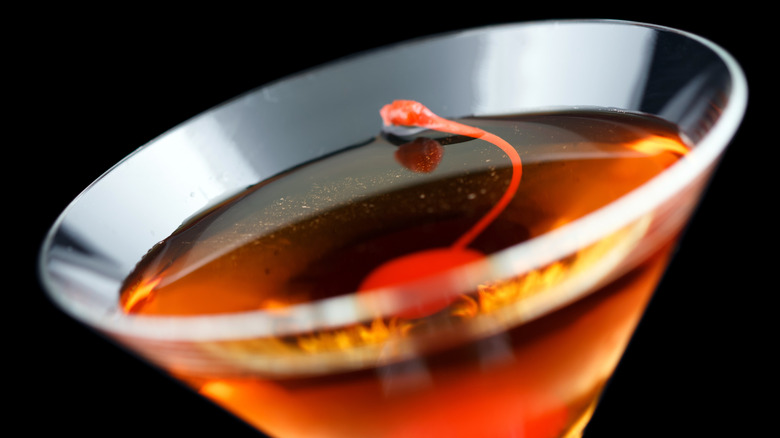 A Rob Roy cocktail in a martini glass with a cherry