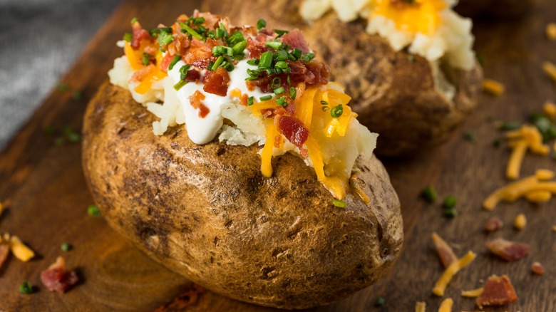 Homemade loaded baked potato with sour cream, chives, cheddar cheese, and bacon.