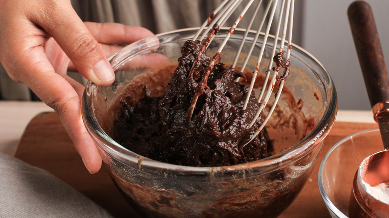 mixing chocolate cake batter with whisk