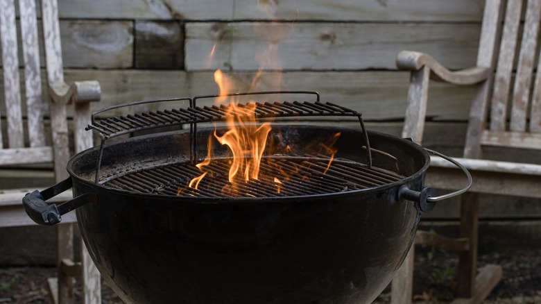 Charcoal grill with flames coming out from top