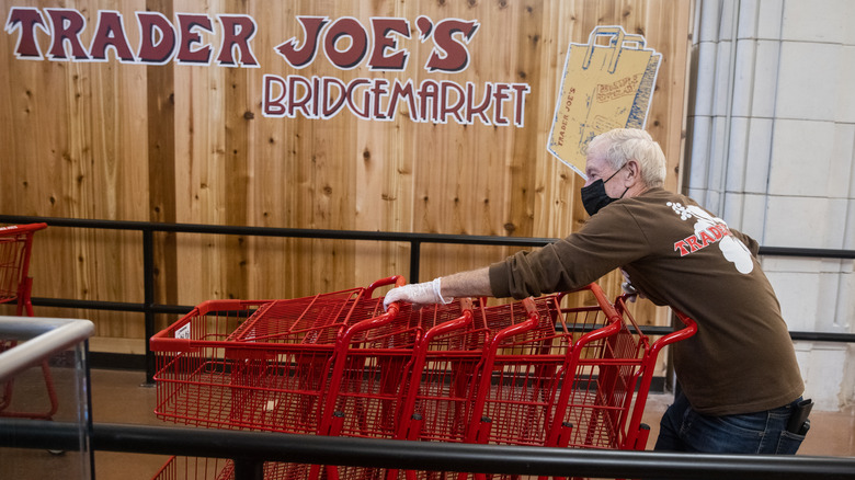 Trader Joe's employee organizing carts