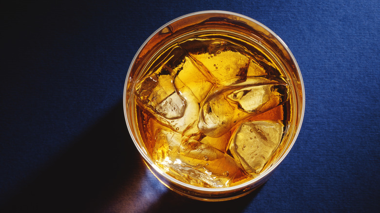 Whiskey in glass with ice cubes