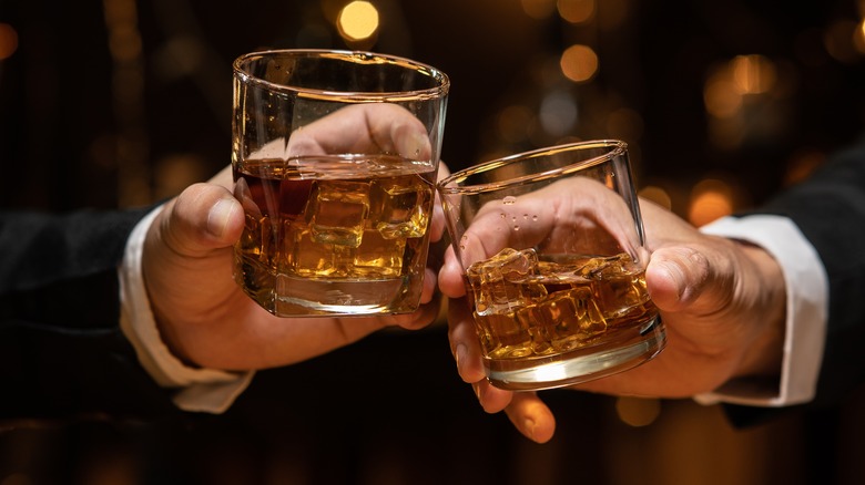 Toasting with two whiskey glasses 