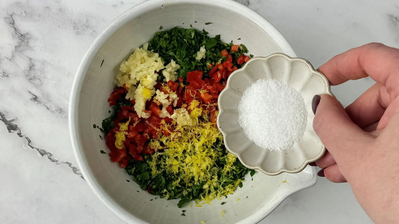 Small bowl of salt pouring into larger bowl