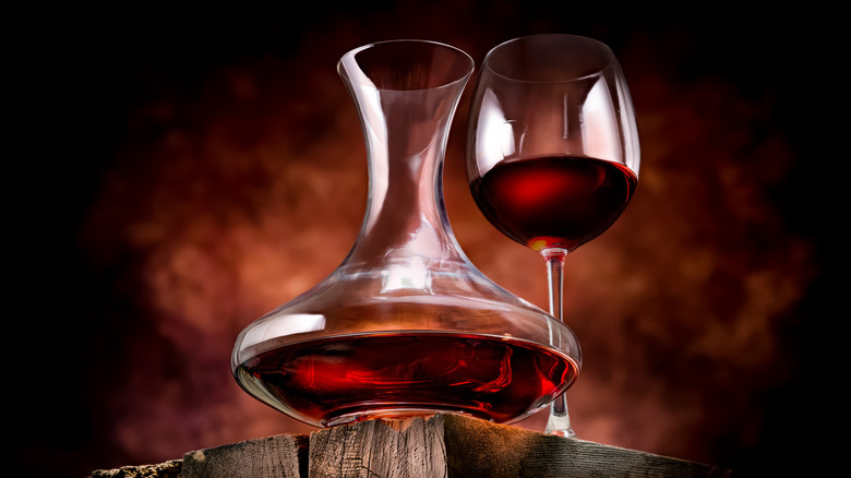 Wine in a decanter and glass on a wooden table