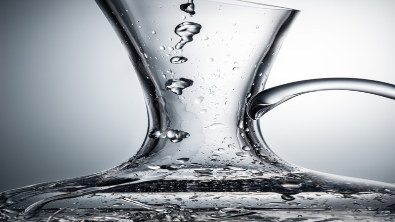 Water flowing into a glass decanter