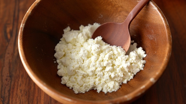 Buttermilk powder in wooden bowl with a spoon