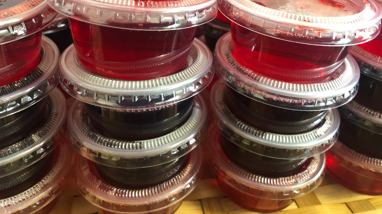 Stacks of Jell-O shots in plastic cups with lids